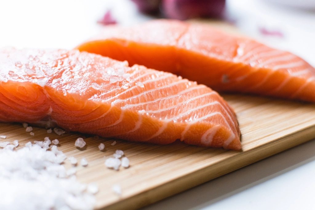 Fresh salmon fillets on a board